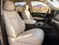 Light beige leather front seats with an Arizona desert landscape visible through the windows