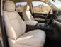 Light beige leather front seats with an Arizona desert landscape visible through the windows