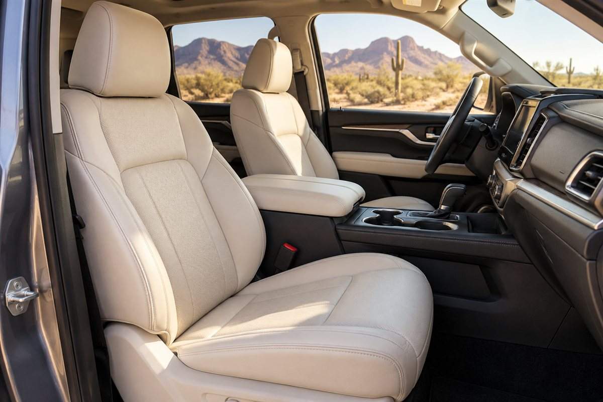 Light beige leather front seats with an Arizona desert landscape visible through the windows